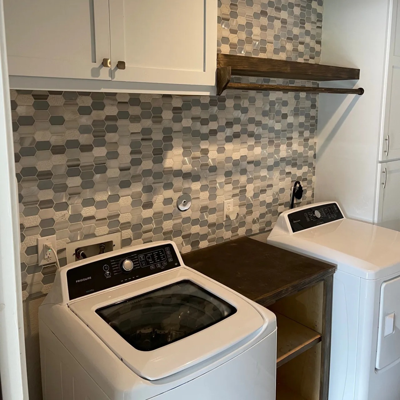 MSS laundry renovation with white cabinets, hexagon tile backsplash, and wood accents