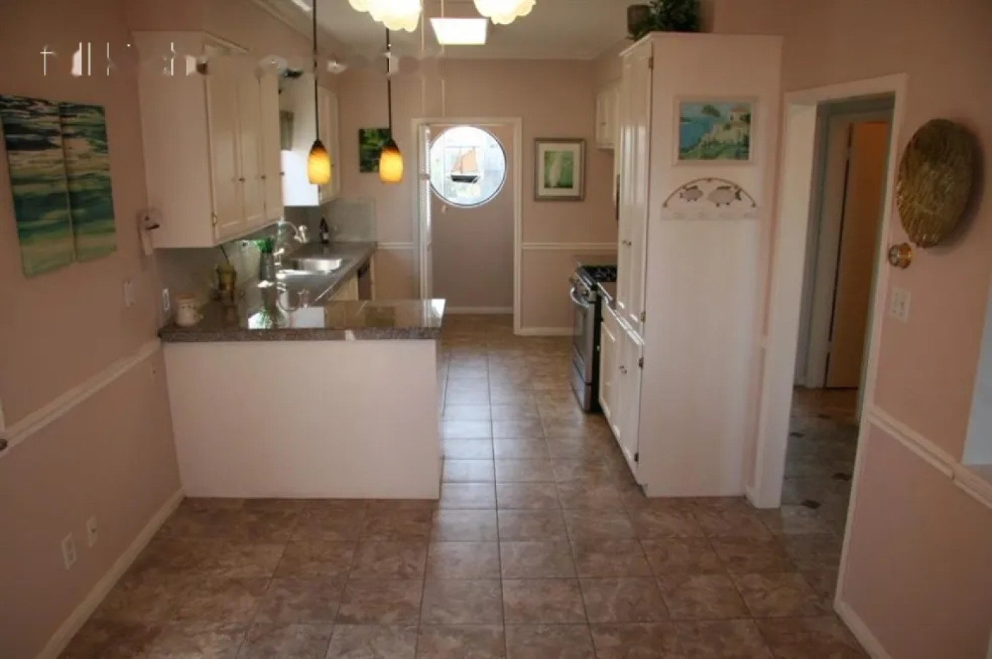 Kitchen before MSS renovation, with granite counters and older finishes